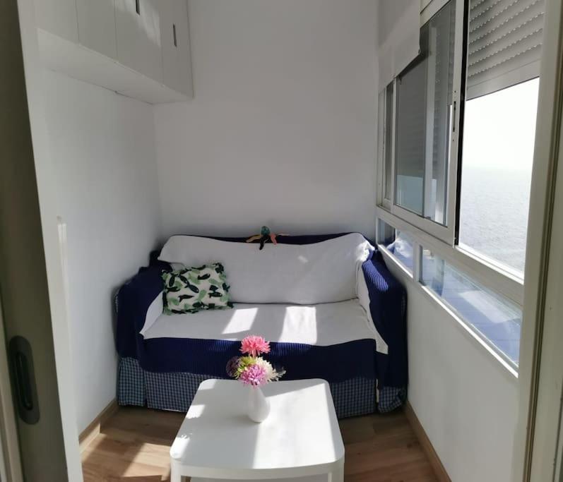 a room with a couch and a table and a window at Estudio reformado primera linea playa in Sitio de Calahonda