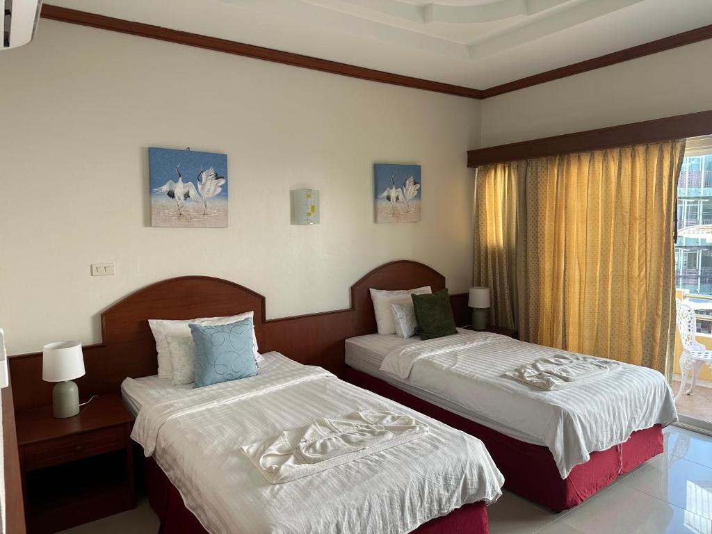 Postel nebo postele na pokoji v ubytování Sabai Sabai hotel