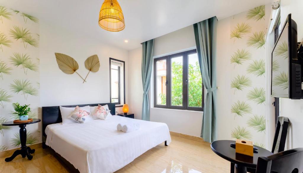 Postel nebo postele na pokoji v ubytování Luna Verde Hotel Hoi An