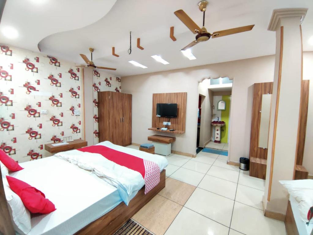 a bedroom with a large bed and a tv at Hotel Grand Stay in Bhopal