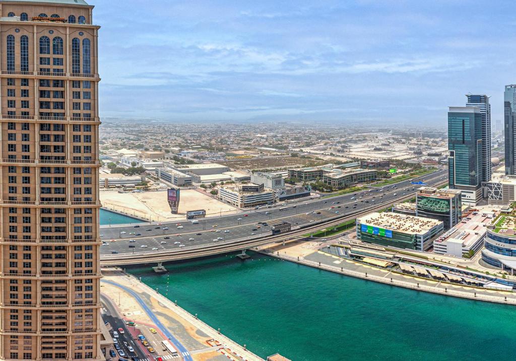 an aerial view of a city with a river and buildings at Al Habtoor City - Noora and Amna Tower, Business Bay in Dubai