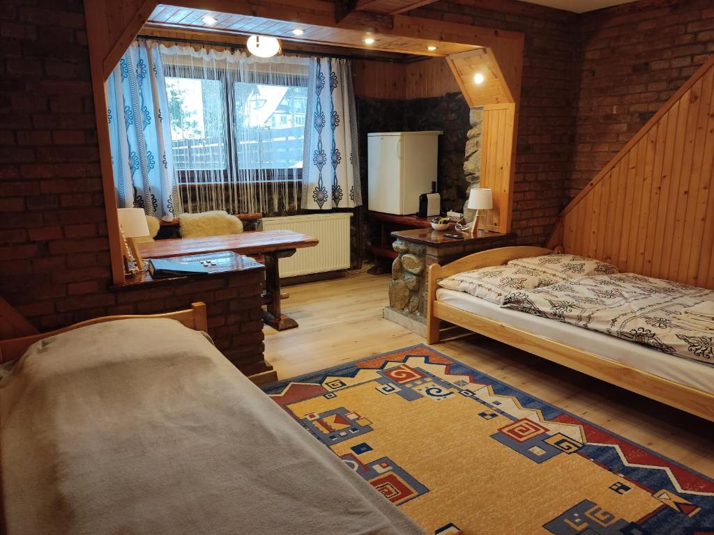 Postel nebo postele na pokoji v ubytování Apartamenty u drwala