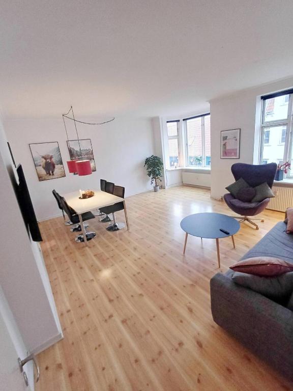 a living room with a couch and a table at Charming Apartment On Pedestrian Street Randers in Randers