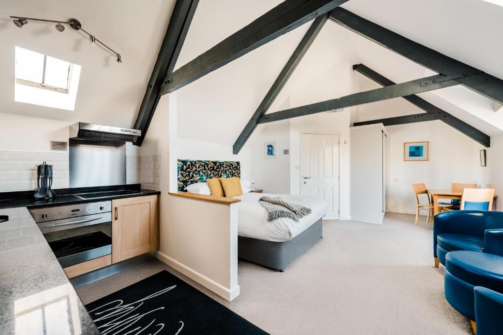 a loft conversions kitchen and living room with a bed at Mannings Hotel in Truro