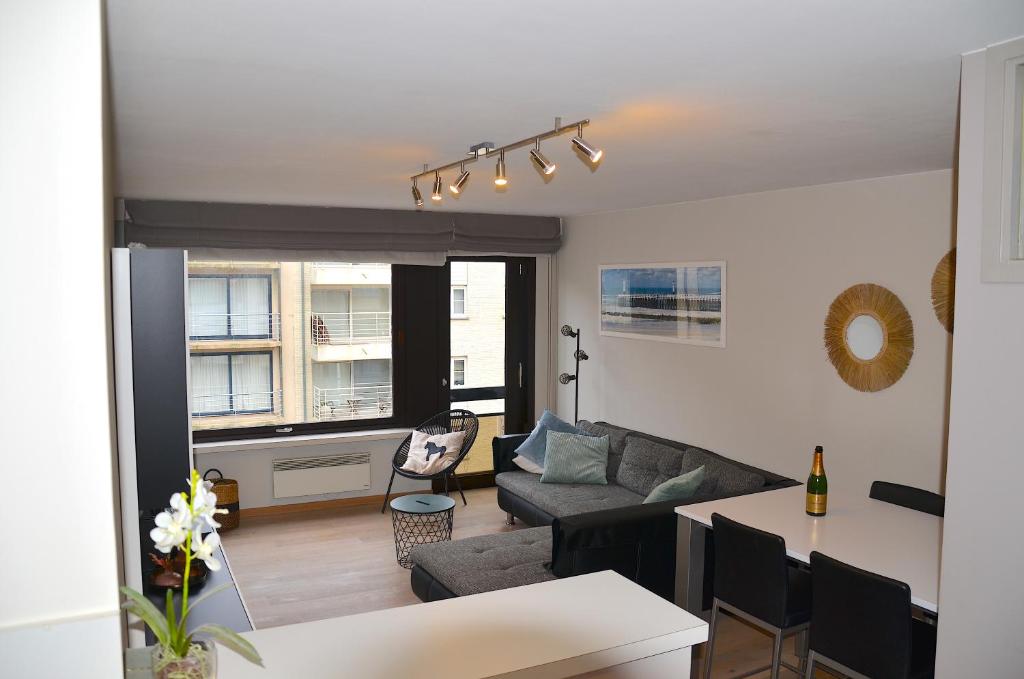 a living room with a couch and a table at SeeYou@Sea in Nieuwpoort