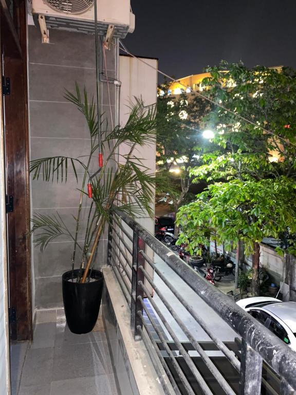 a potted plant sitting on the side of a balcony at Nhà Nghỉ Ánh Ngọc in Hue