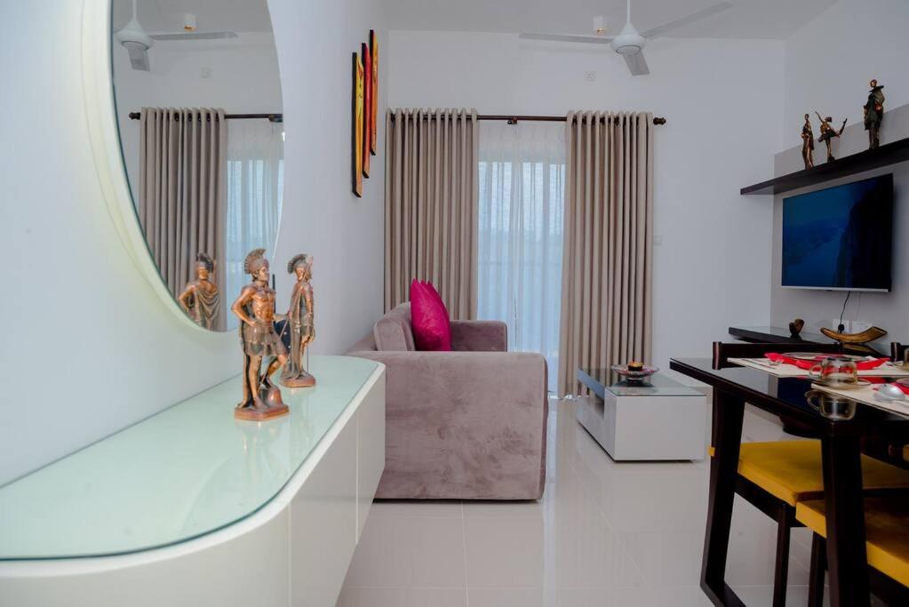 a living room with a couch and a mirror at Apartment -Piliyandala Kahathuduwa in Gonapola