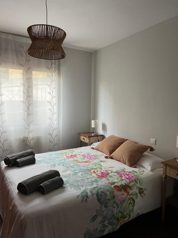 a bedroom with a large bed with two pillows on it at LA TERRAZA in Comillas