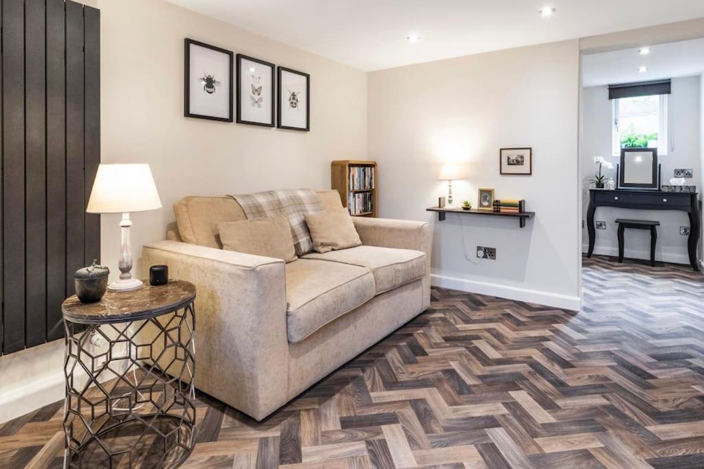 a living room with a couch and a table at The Holt - Ilkley, central location, stylish apartment in Middleton