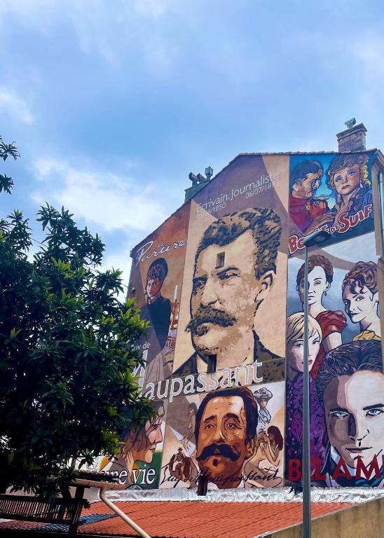 a building with a large painting on the side of it at Villa Corbelle - Grand Studio in Cannes