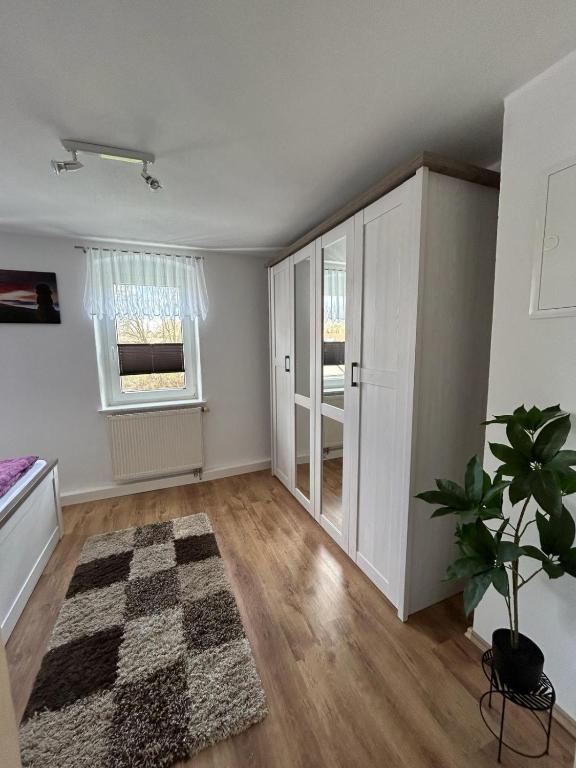 an empty living room with a rug on the floor at Ferienwohnung Streit in Kurort Gohrisch