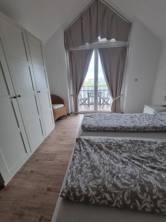 Postel nebo postele na pokoji v ubytování Nordseehaus Dangast