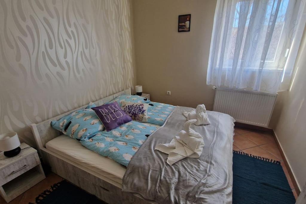 a bedroom with a bed with a stuffed animal on it at Jackpot Apartman in Budapest
