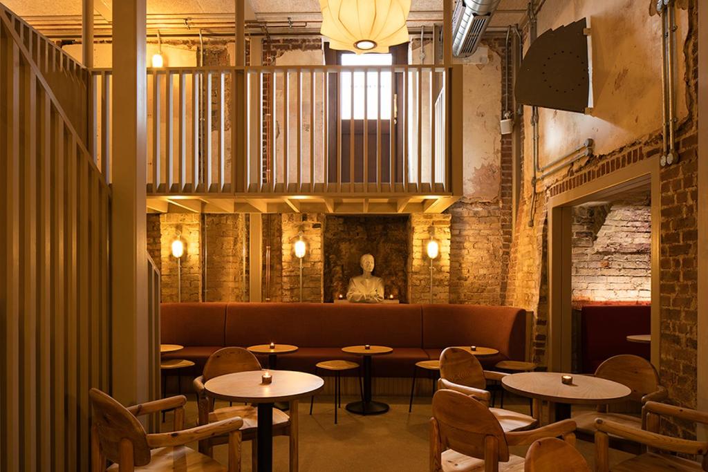 a restaurant with tables and chairs in a room at Fort Road Hotel in Margate