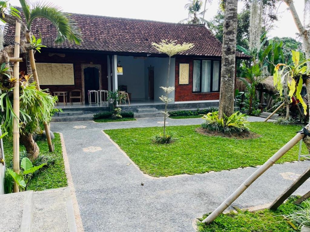 a house with a pathway leading to the front of it at Yasa Backpackers house in Ubud