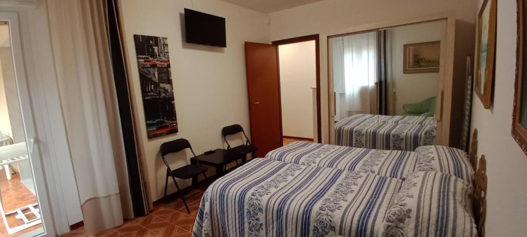 a hotel room with two beds and a mirror at Appartamento Giusy in Ventimiglia
