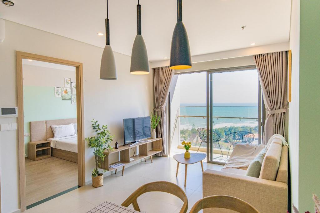 a living room with a view of the ocean at The Sóng Luxury Condotel Vũng Tàu - Dori's House in Vung Tau