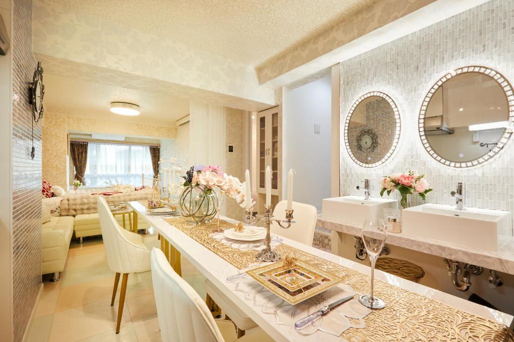 a bathroom with two sinks and a living room at Papillon Paradis Higashi-Shinjuku in Tokyo