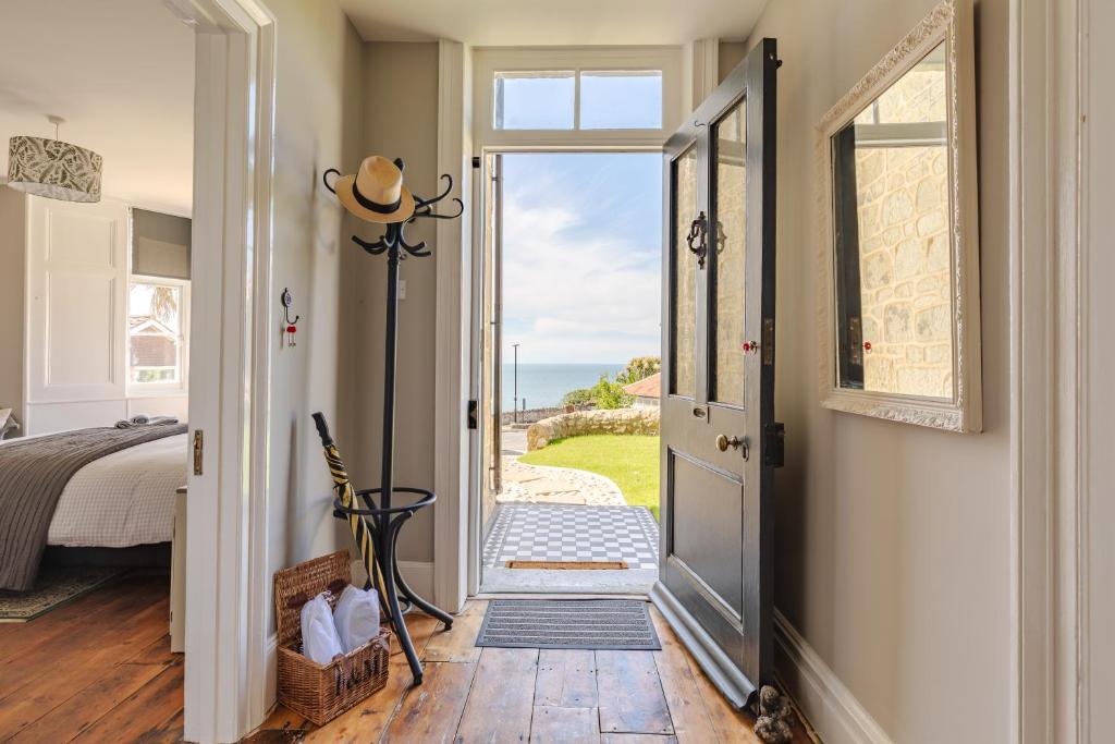 a door leading to a bedroom with a view of the ocean at Jaw-dropping view over the English Channel in Wroxall