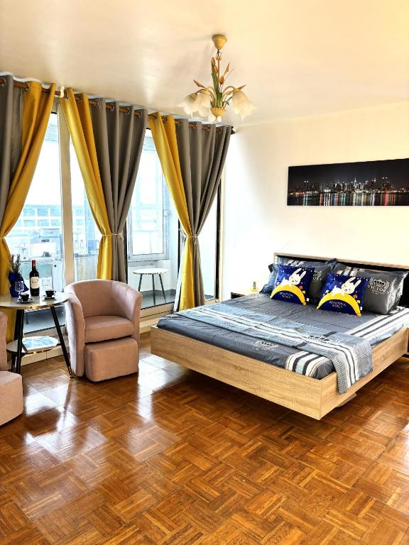 une chambre avec un lit et une chaise dans l'établissement Chambre Arena Porte La Chapelle, à Paris