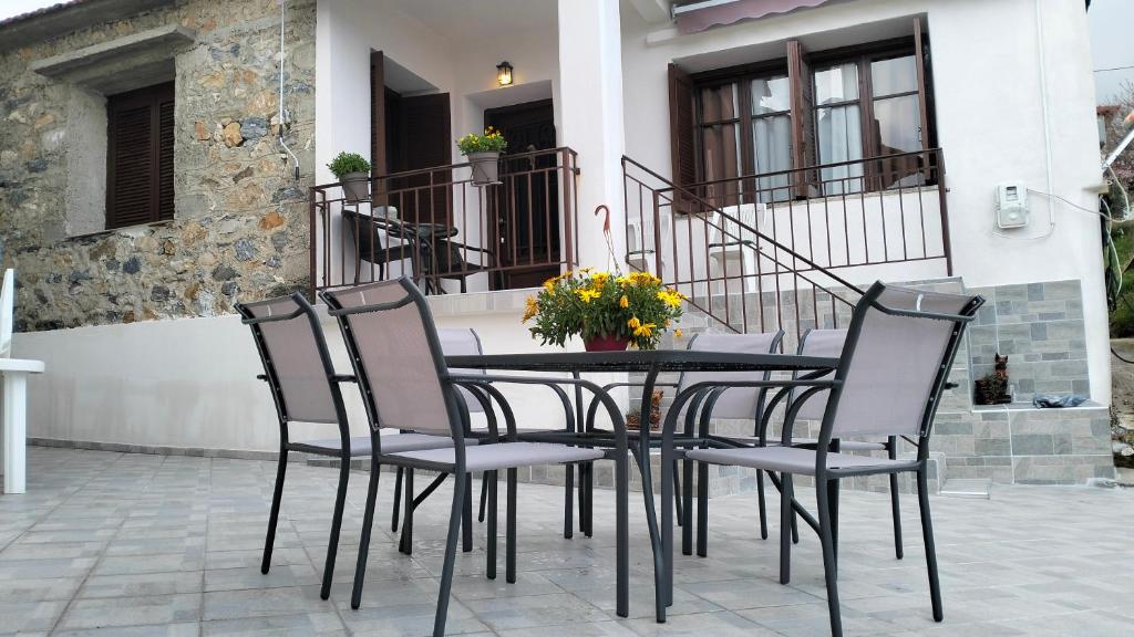 a black table and chairs on a patio at Blue View-Μπλε Θέα in Aigáni