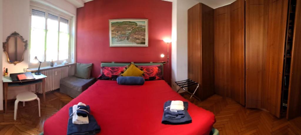 een rode slaapkamer met een bed met een rode deken bij Flat city center Porta Susa, free parking wifii smart tv Sky in Turijn