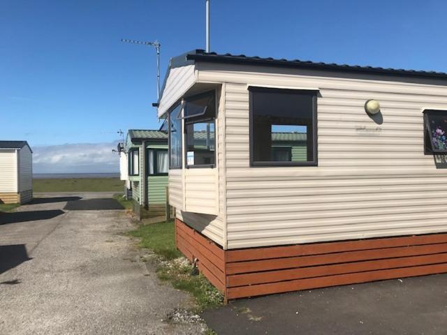 a mobile home is parked in a parking lot at Ocean Edge Holiday Home in Heysham