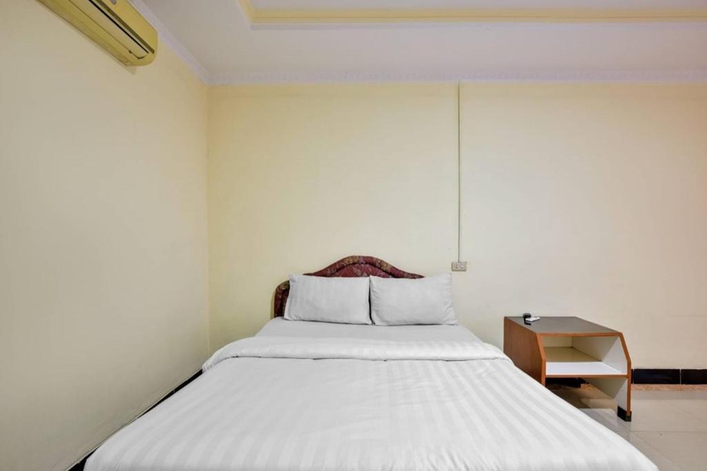 Postel nebo postele na pokoji v ubytování Malibou Hotel Medan