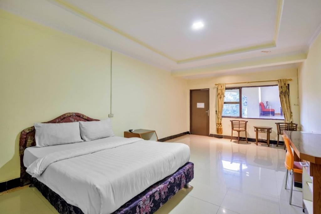 Postel nebo postele na pokoji v ubytování Malibou Hotel Medan