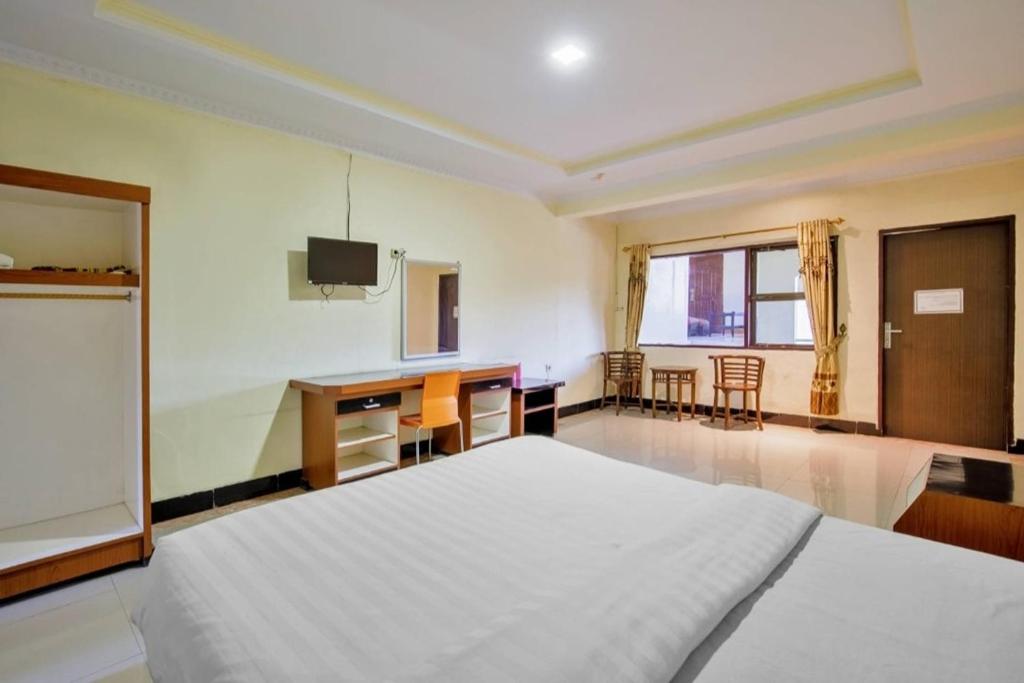 Postel nebo postele na pokoji v ubytování Malibou Hotel Medan