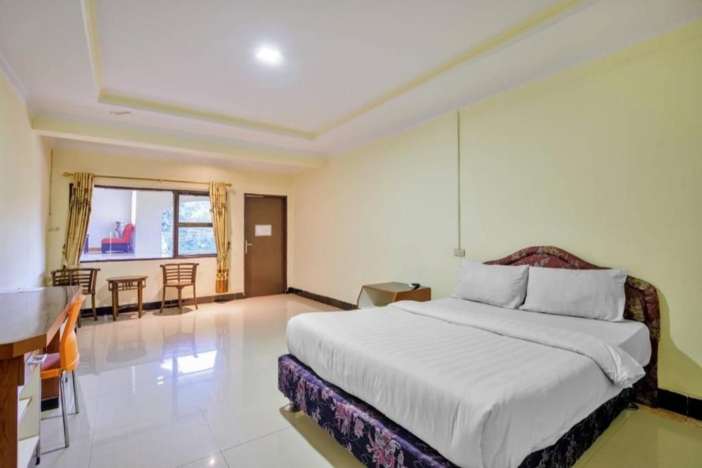 Postel nebo postele na pokoji v ubytování Malibou Hotel Medan