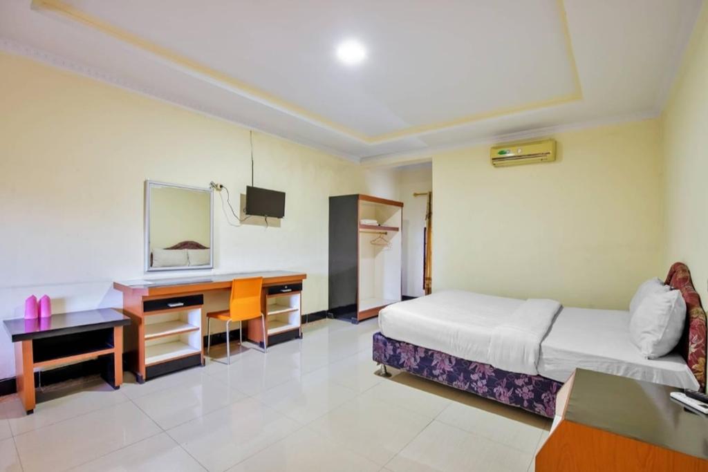 Postel nebo postele na pokoji v ubytování Malibou Hotel Medan
