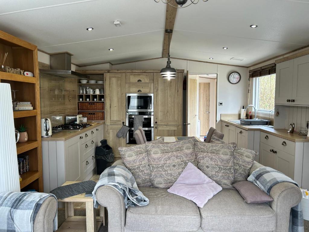 a living room with a couch in a kitchen at Roadnights Retreat in Heysham