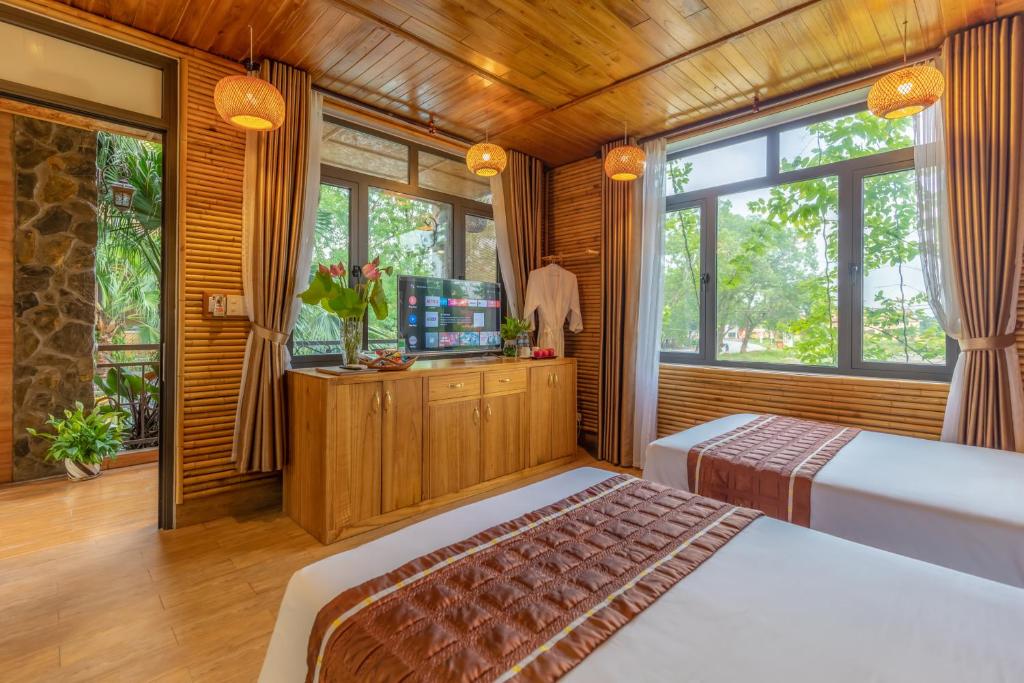 Postel nebo postele na pokoji v ubytování Tam Coc Serenity Hotel & Bungalow