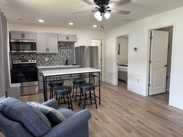 a kitchen and living room with a couch and a table at Sunset Beach Resort in Osage Beach