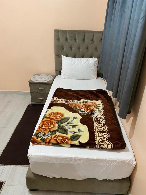 a bedroom with a bed with a blanket on it at Résidence AGDAL in Dakhla