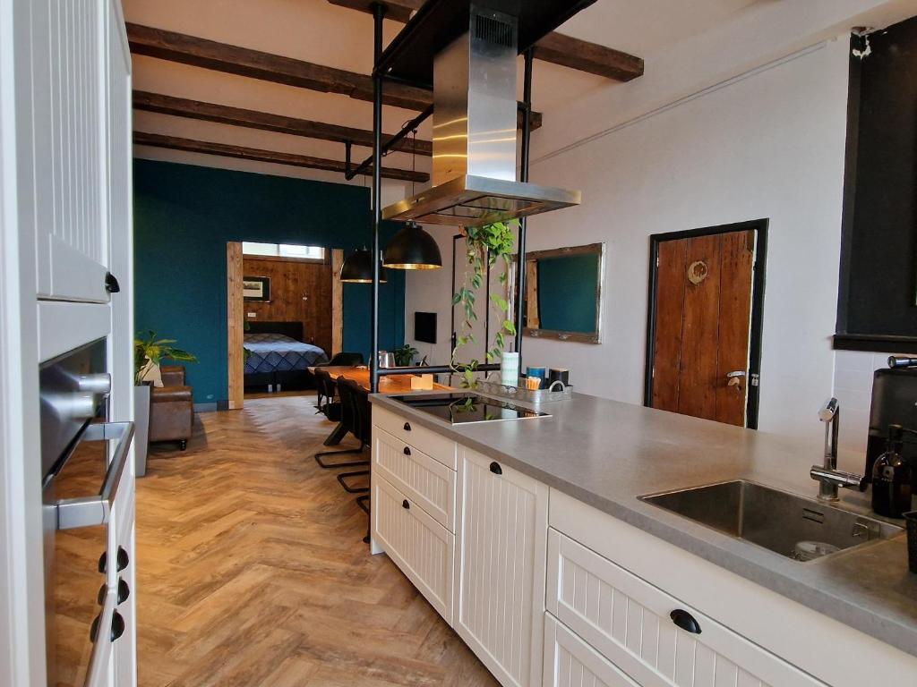 a kitchen with a sink and a counter top at Appartement Bierkade in Alkmaar