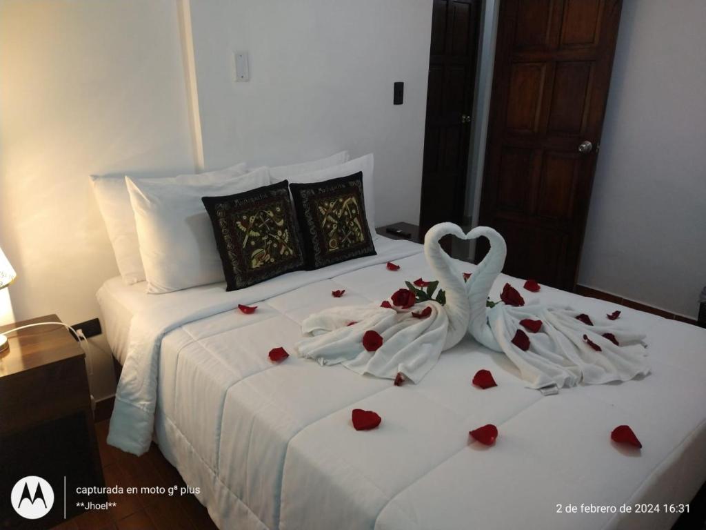 a bedroom with a bed with a couple of hearts at Ortega's House Machupicchu in Machu Picchu