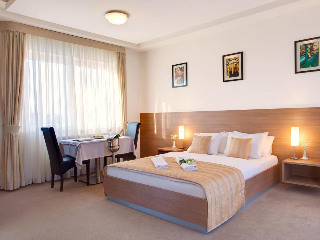 Habitación de hotel con cama y mesa en Hotel Knezevina, en Vranić