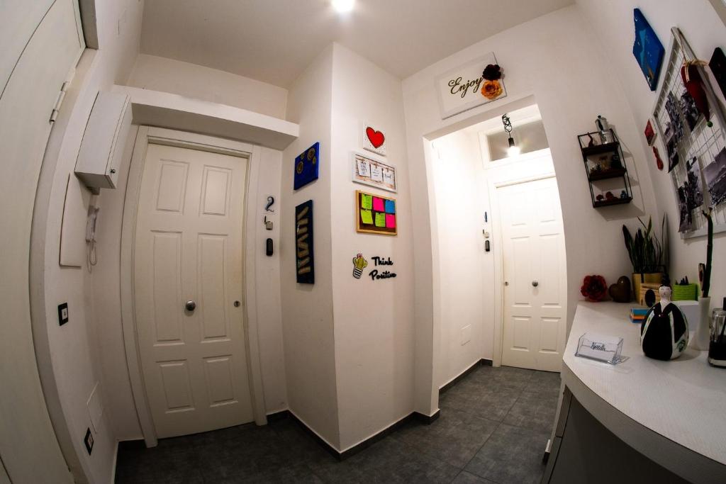 a hallway with two white doors in a room at Pupatella Apartments in Naples