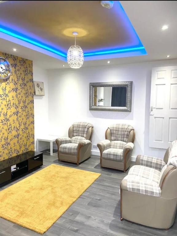 a living room with couches and a blue light at Comfy 2 Bedroom House Near Leeds City Centre in Leeds