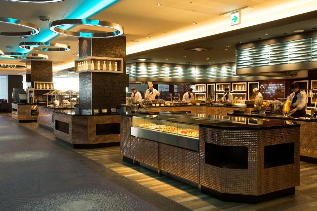 a restaurant with people standing around a buffet at Shin Yokohama Prince Hotel in Yokohama