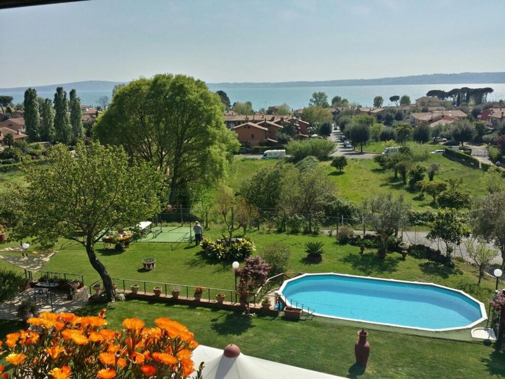 a view of a yard with a swimming pool at La Cupoletta -Holiday House - GILDA in Trevignano Romano