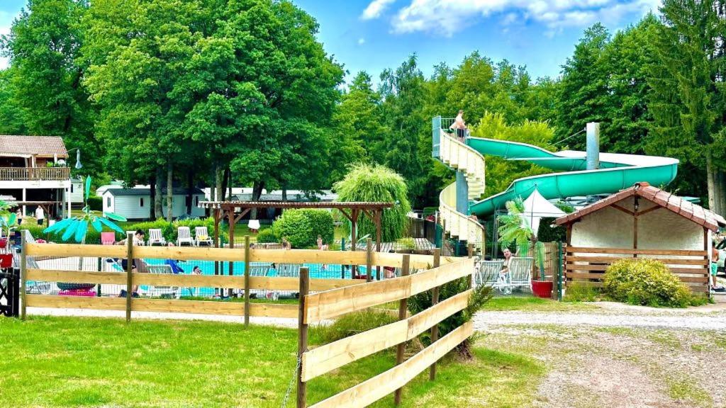 a water park with a slide and a pool at Le chalet de DOMY in Granges-sur-Vologne