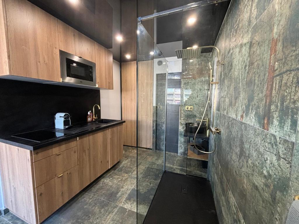 une salle de bain avec une douche et un lavabo et une cabine de douche en verre dans l'établissement Studio port nature 1, au Cap d'Agde