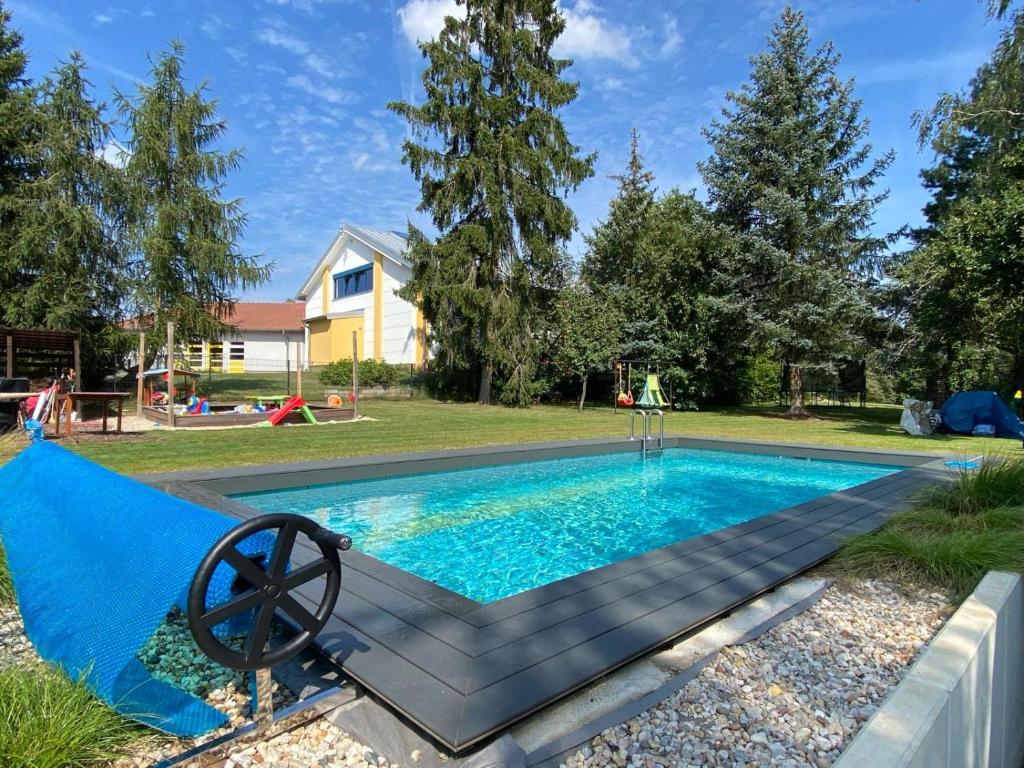a swimming pool with a blue tarp around it at helle Ferienwohnung in Architektenhaus mit Garten und Pool in Bad Belzig