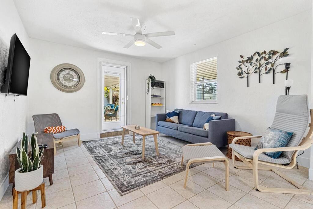 a living room with a blue couch and chairs at Fun Get Togethers at the Beach! in St. Pete Beach