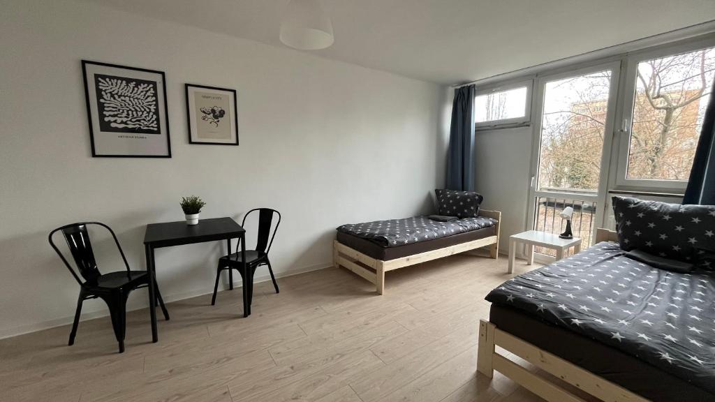 a bedroom with a bed and a table and chairs at Rooms in Warsaw - G5 in Warsaw