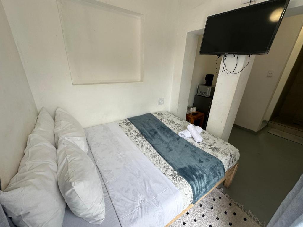 een slaapkamer met een bed en een flatscreen-tv bij Southernwood nest in East London