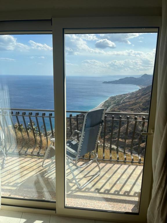 a room with a view of the ocean from a balcony at The breath from The soul in Forza dʼAgro